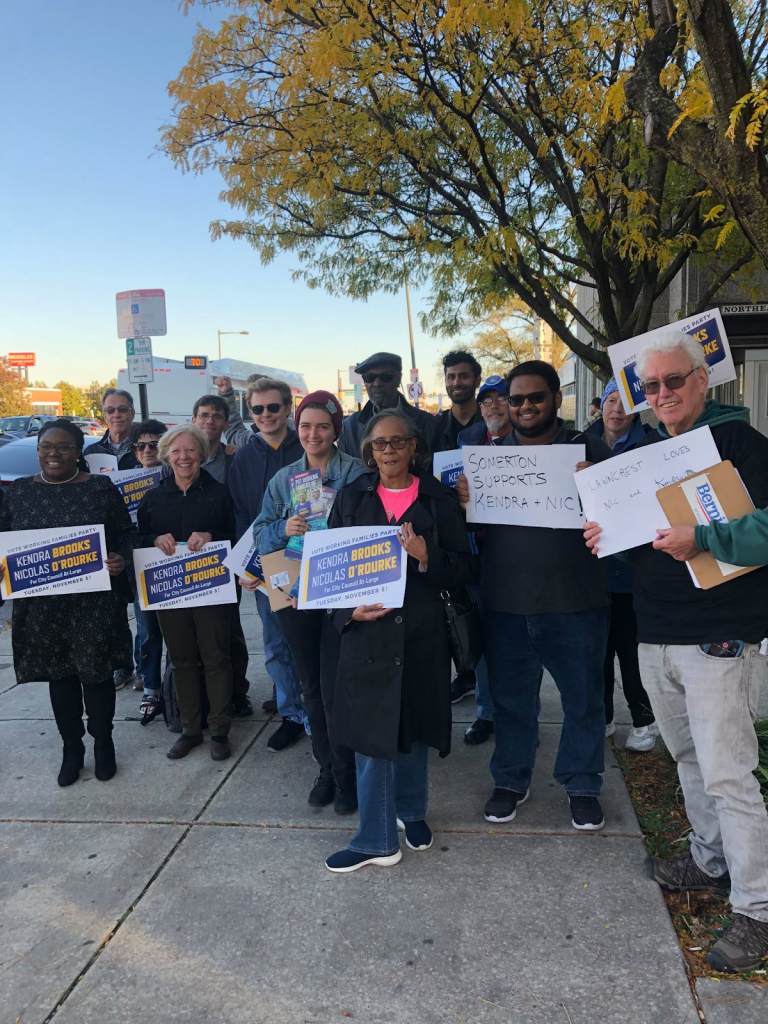 215 PA Members stand with signs supporting Kendra Brooks and Nicolas O'Rourke for City Council